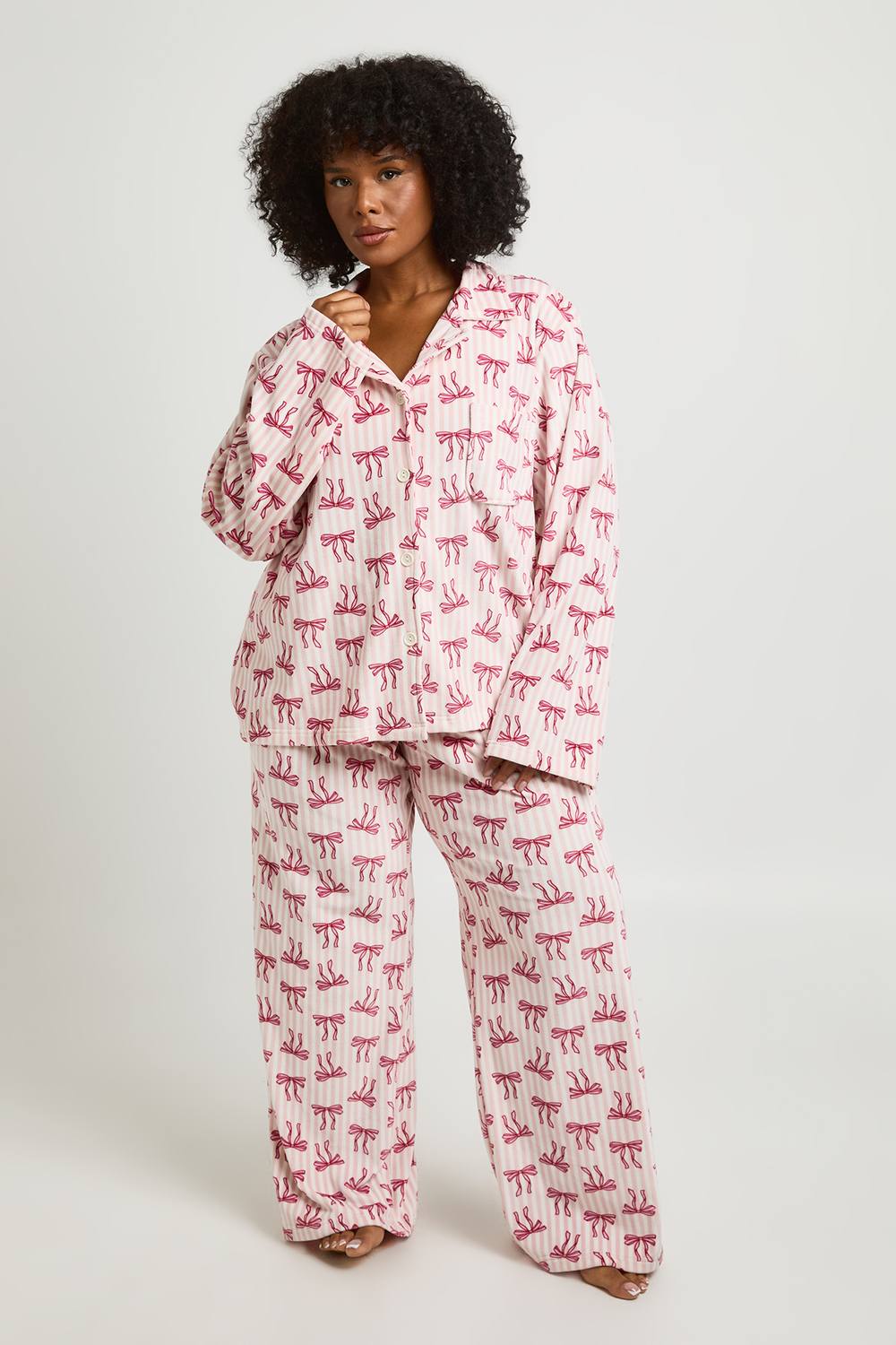 boohoo Women's Plus Pinstripe Bow Print Fleece Long Sleeve Shirt & Trouser Pyjama Set in Baby Pink by boohoo