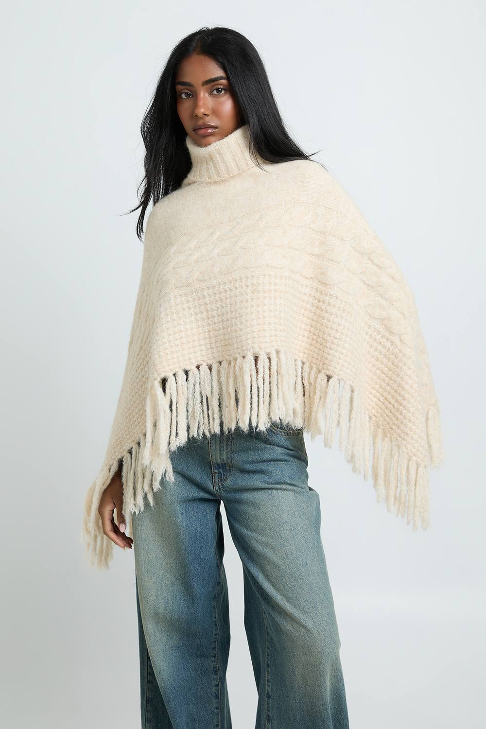 boohoo Women's Roll Neck Cable Detail Tassel Hem Cape in Oatmeal by boohoo